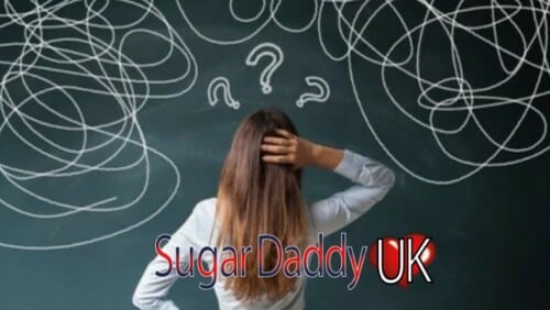 girl looks at a blackboard seems confused the blackboard has scratches and question marks